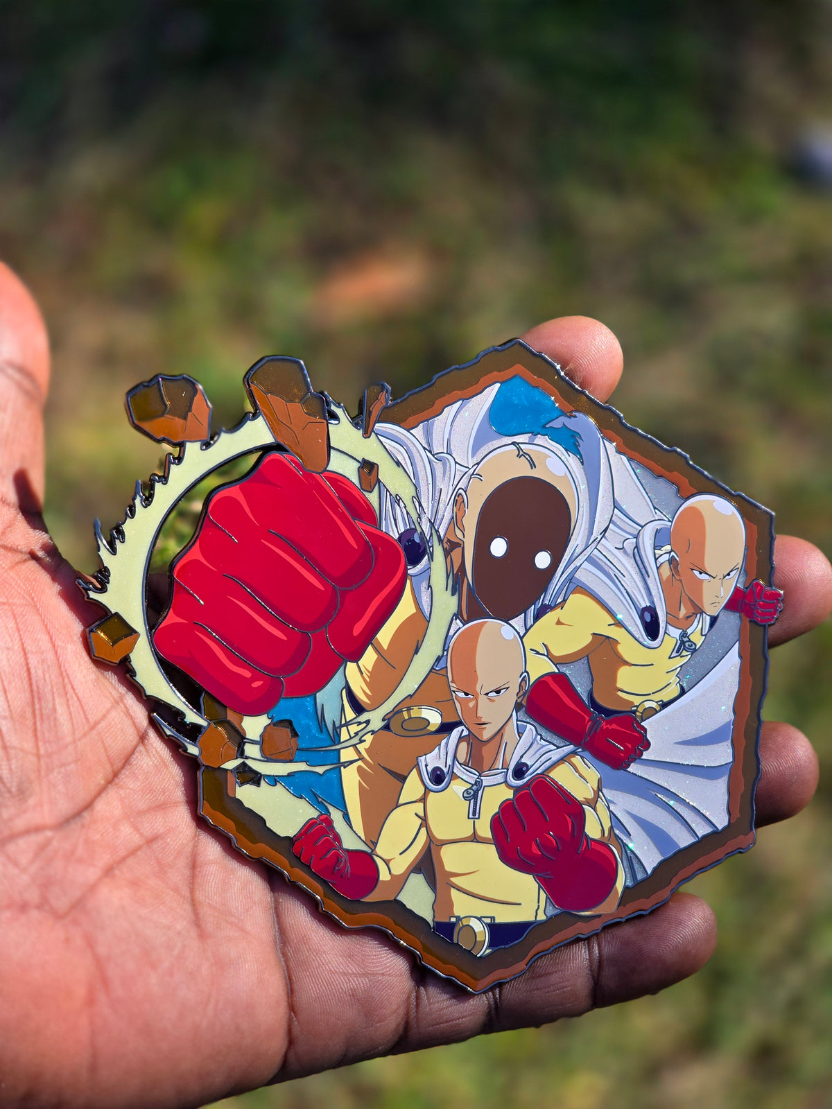 Mega punch enamel pin in hand